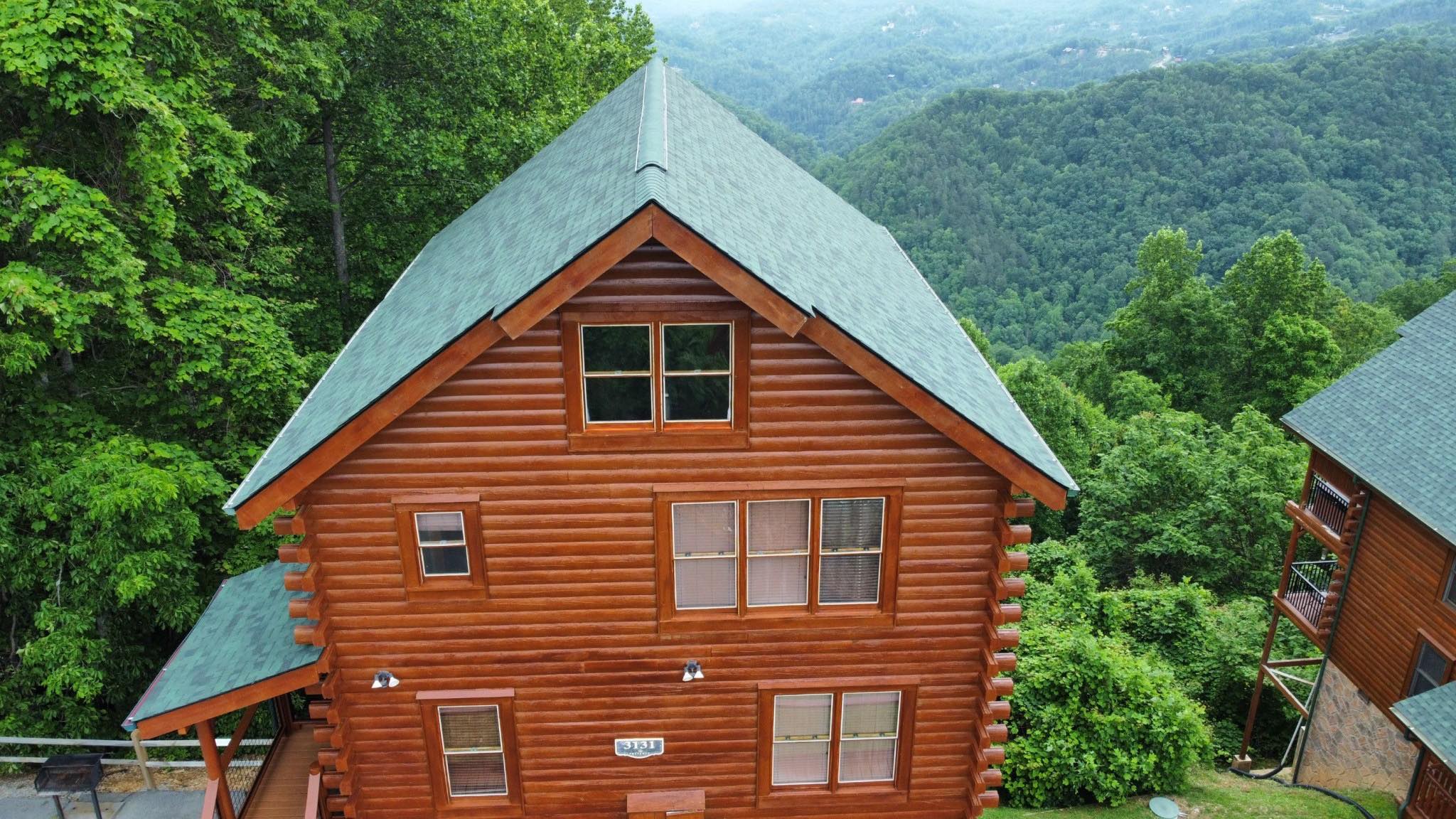 Smoky Mountain log cabin with a finished standing-seam metal roof installed by Brian King Roofing