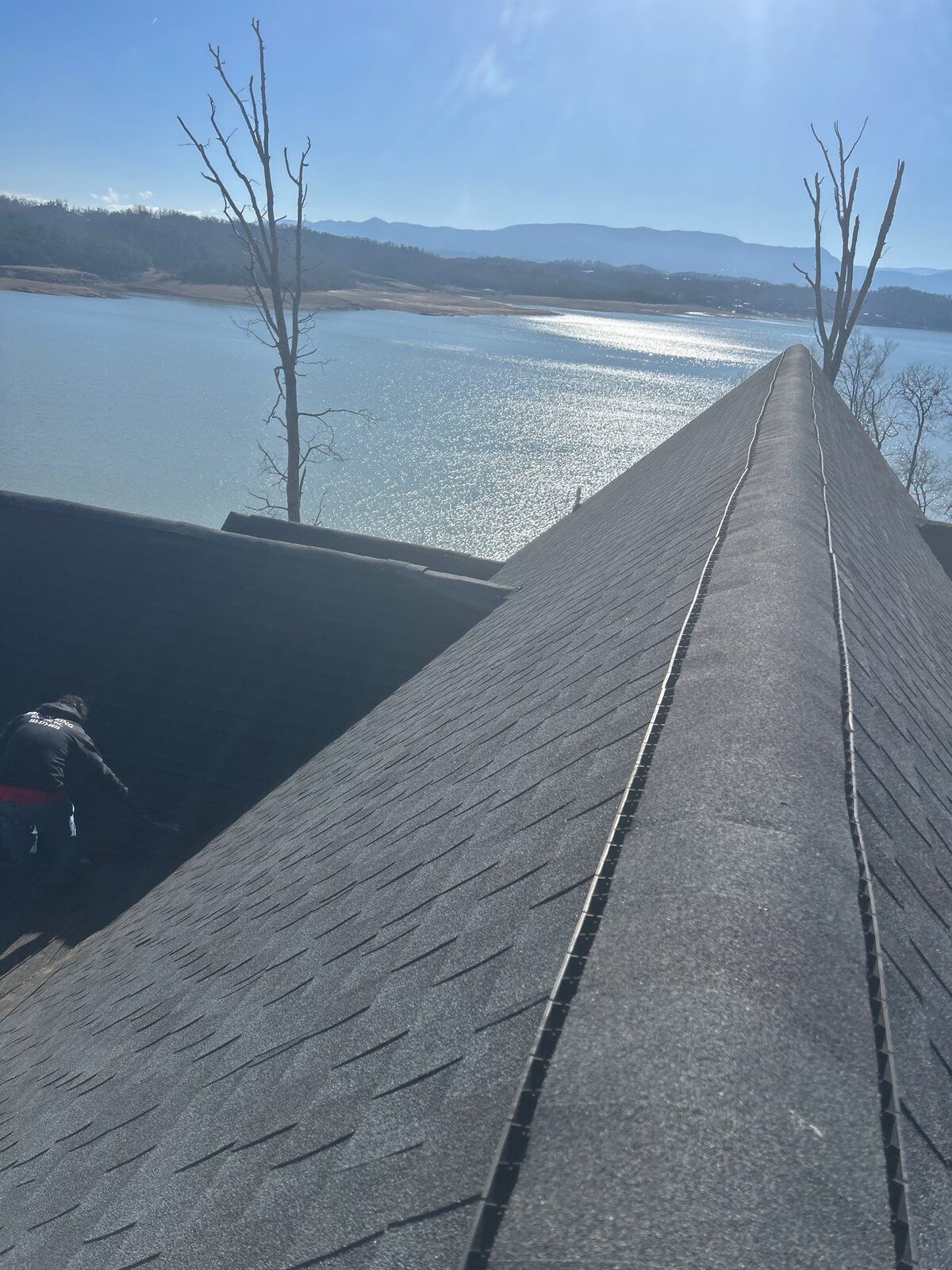New shingle roof ridge with a lake in the background
